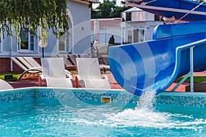 Water fun in the pool, slide. Concept, cheerful, perky bright colorful summer and relaxation. View from above