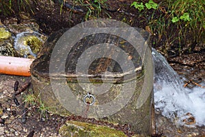 Water gatherer in Dolomiti mountains, Italy