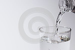 Water in glass put on table under the blue sky reflection for healthy or drink, nature concept
