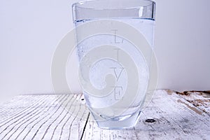 Water glass with the word live