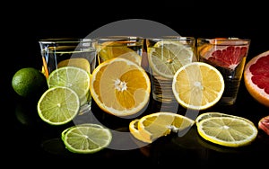 Water glasses with citrus fruits, lemonade concept.