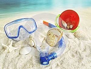 Water goggles and toys in the sand