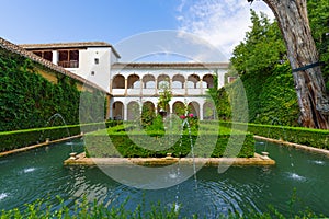 Water, green and coolness of Generalife Garden on a sunny hot day. Alhambra, Granada, Andalusia, Spain