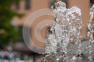 Water gurgling from a street fountain. A splash of water in a fountain, an abstract image