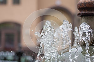 Water gurgling from a street fountain. A splash of water in a fountain, an abstract image