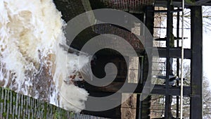 Water gushing out at high speed between the gates of the small dam