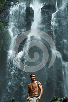 Water. Healthy Man With Body Near Waterfall. Healthcare