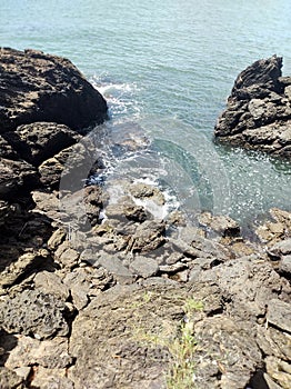 Water hitting the rocks on a beach in BalneÃ¡rio Camboriu, SC, Brazil