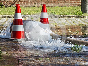 Water hose with pylons on the street