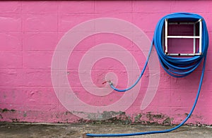 Water hose winder wall pink.