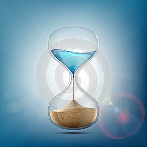 Water in hourglass becomes a sand. Stock . photo