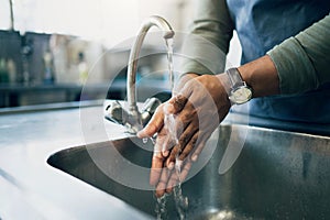 Water, hygiene and washing hands in the kitchen with a person by the sink for health or wellness. Cleaning, safety and