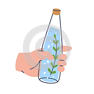 Water infused with rosemary leaf. Holding aromatic fresh aqua bottle in hand. Refreshing summer detox drink, refreshment