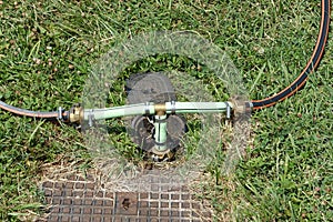 Water irrigation system in garden with two hosepipes attached to water supply photo