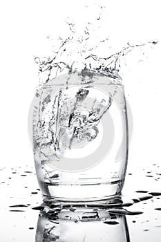 Water isolate splash in cup on white background