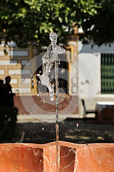 Water jet closeup of a beautiful marble fountain in Plaza de DoÃÂ±a Elvira, Seville, Spain photo