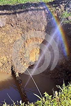 The water jet in the form of leakage in the damaged metal pipe a