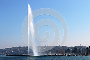 Water jet in Geneva cityscape Switzerland. City, lake et mountains