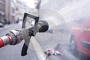 Water jet splashing from a fire fighting firehose nozzle