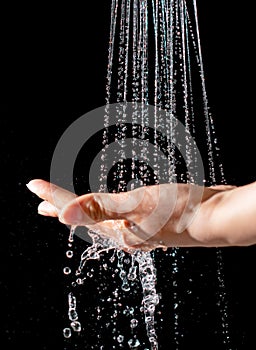 Water jet with spray on a black background