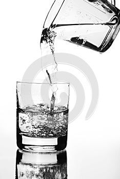 Water jug pouring into glass