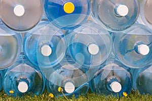 Water Jugs Stacked on Grass photo