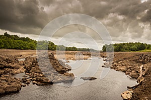 Water of Ken flowing out of a gorge on a drained or dewatered Earlstoun Dam