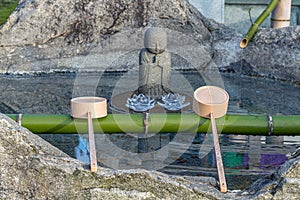 Water and ladles hishaku for the ceremonial washing of hands rite temizu, Japan