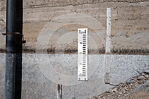 Water level gages on the cement walk of a diversion dam