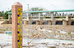 Water level gauge on the pole at the dam