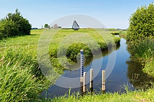 Water level staff gauge in ditch in polder, Netherlands