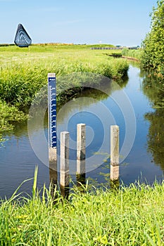 Water level staff gauge in ditch in polder, Netherlands