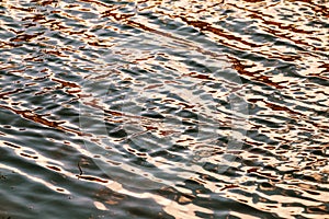 Water level, water in motion. Reflected structure of the surroundings is distorted by the movement of water. Abstract blue backgro