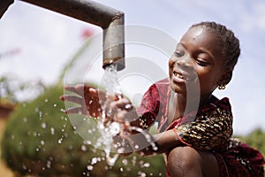 Water is Life for African Children, Little Gorgeous Black Girl Drinking from Tap