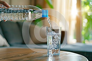 water is life, scene of pouring purified fresh drink water from the bottle on table in living room