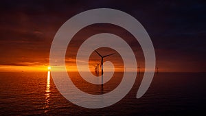 Sunset offshore at wind turbine farm