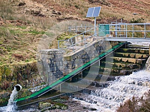 Water management infrastructure on the Whitendale River in Lancashire, UK. A green eel - elver pass is shown. photo