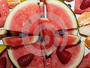 water melon fruit bowl strawberries wild berries and mandarin fruits creating nice colourful food platter