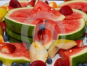 water melon fruit bowl strawberries wild berries and mandarin fruits creating nice colourful food platter
