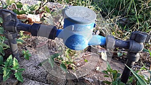 Water meter,black pipe on concrete floor.