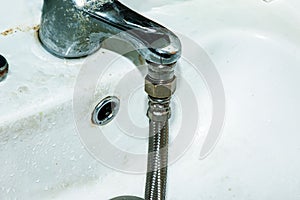 Water meter verification process. A flexible water hose is connected to the water tap. Water saving concept