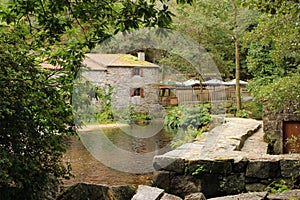 Water mills next to a waterfall on the lake