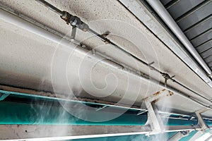 Water mist cooling system on ceiling lowers tropical ambient temperature