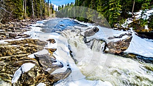 The Murtle River tumbles over the edge of the partly frozen Mushbowl Falls in BC, Canada