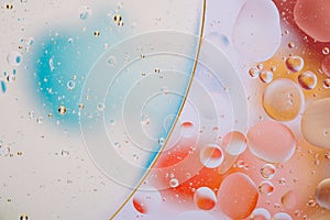 Water oil bubble macro abstract background flow liquid blue white aqua red orange colors