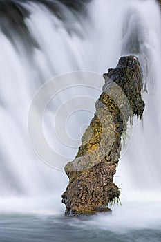 Water Over A Dam with Driftwood