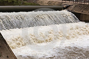 Water over rubber dam blocking the river for agriculture