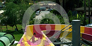 In the water park a child descends from the slide