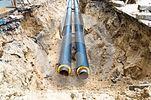 Water pipes in ground pit trench ditch during plumbing under construction repairing