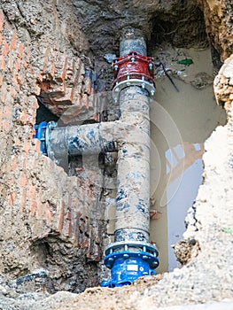 Water pipes in ground pit trench ditch during plumbing under construction repairing